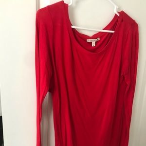 Red long sleeve top. Short back.